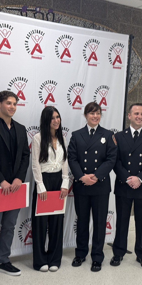 Keira receiving Youth Assistance Bloomfield award with first responders